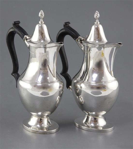 A pair of George V silver hot water or cafe au lait pots by Nathan & Hayes, gross 15 oz.